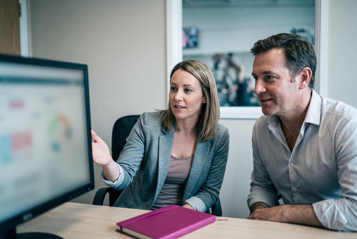 A regional manager and a franchisee discuss their location's metrics